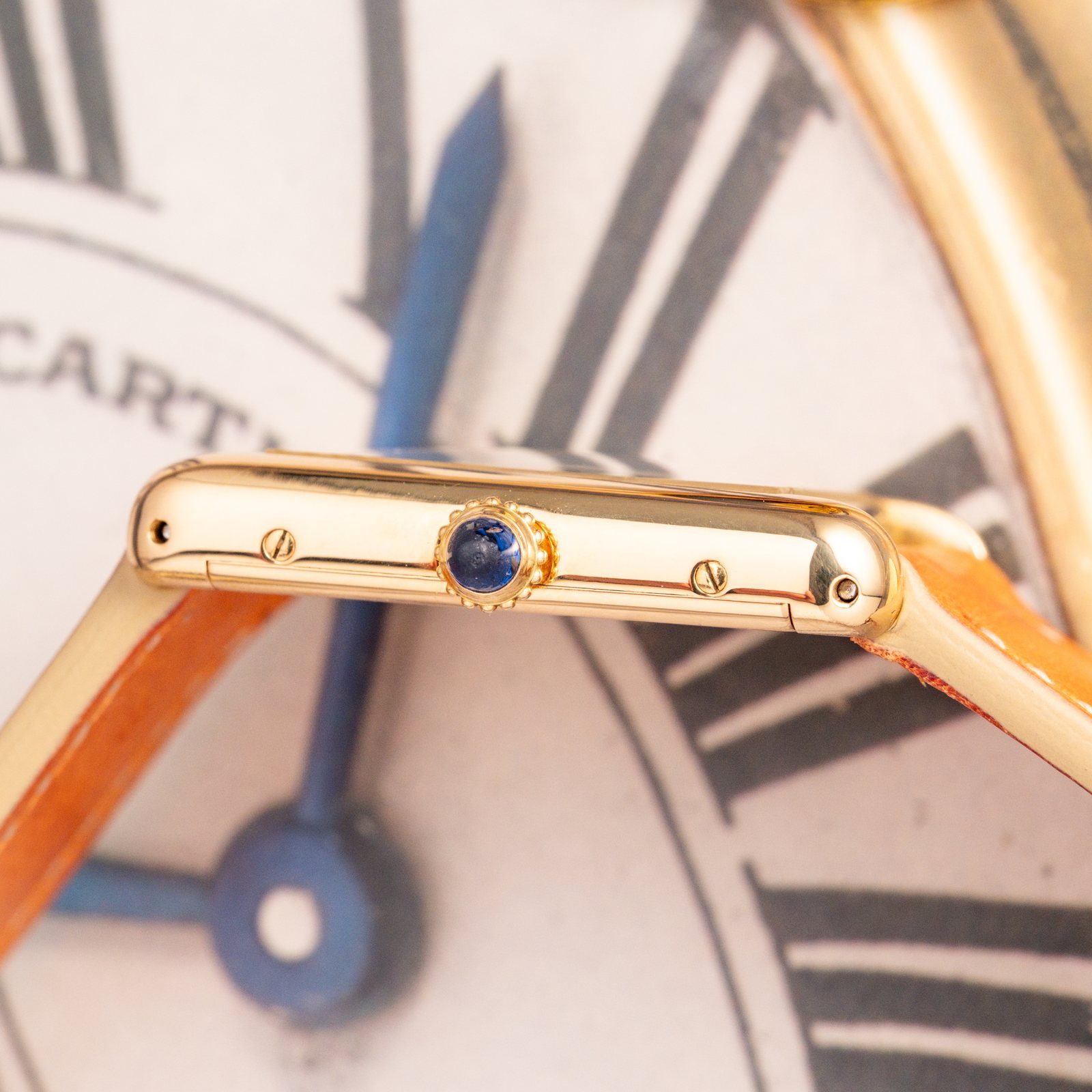 Side view of the Tank Louis Cartier 78086 showing the sapphire cabochon crown